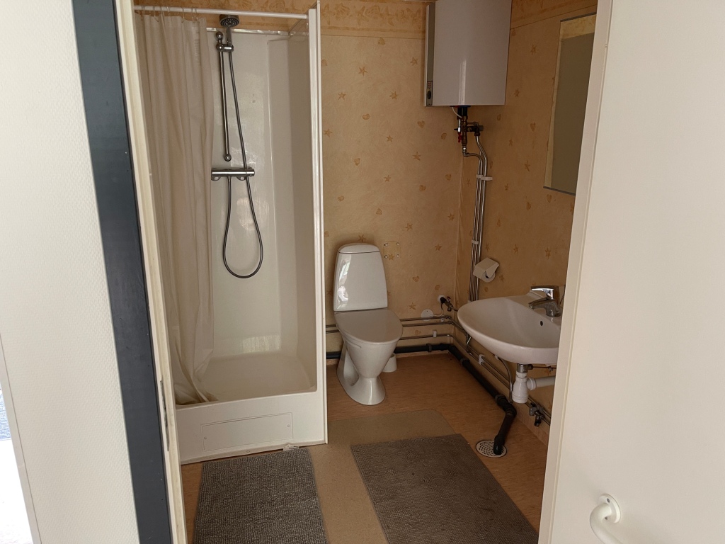 Beboelsespavillon indeholder køkken og garderobeskab samt toilet/bad. Varmtvandsbeholder og varmepumpe.